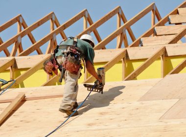 30379288_l 30379288 - construction crew working on the roof sheeting of a new, two story, commercial appartment building in oregon
